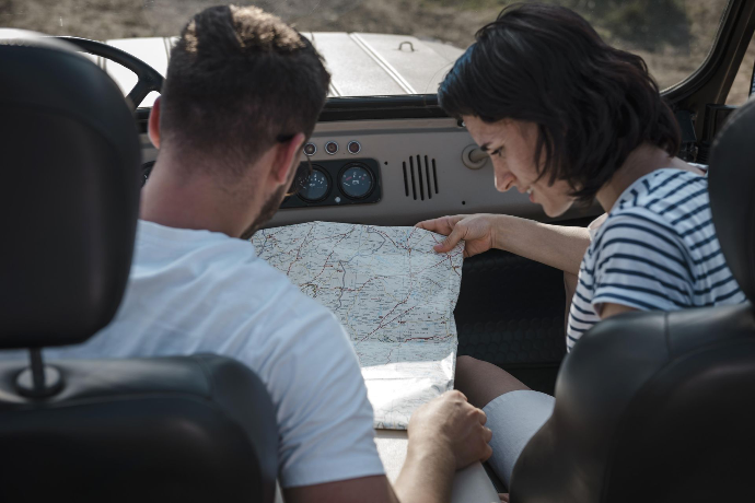 two people planning their itinerary two people planning their itinerary